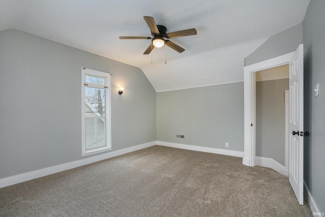 bonus room featuring carpet, ceiling fan, lofted ceiling, and a textured ceiling