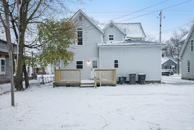 snow covered property featuring a wooden deck