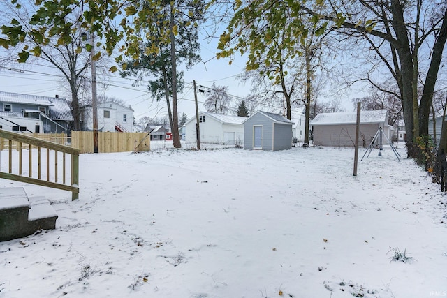 snowy yard with a shed