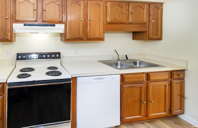 kitchen featuring range with electric stovetop, sink, white dishwasher, and light hardwood / wood-style floors