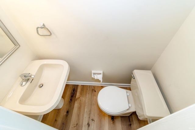 bathroom featuring sink, hardwood / wood-style floors, and toilet