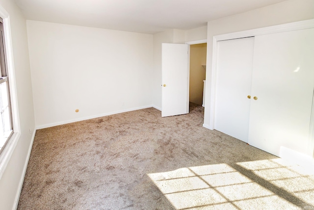 unfurnished bedroom with carpet floors and a closet