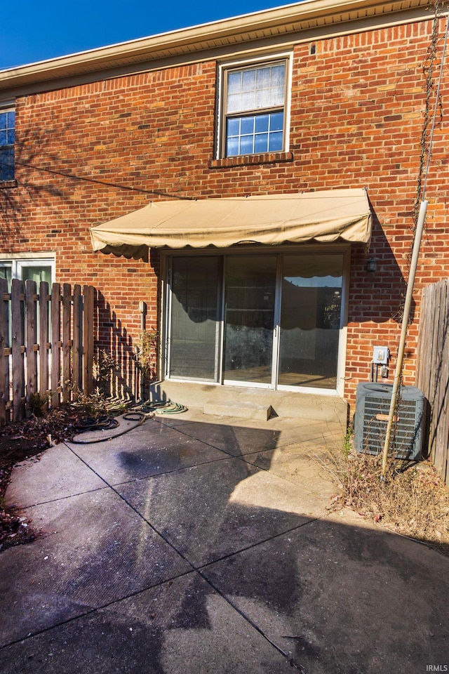 back of house featuring central AC unit and a patio