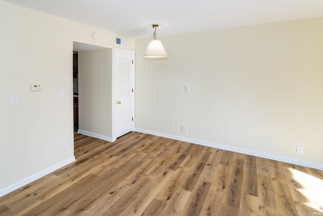 unfurnished room with hardwood / wood-style flooring