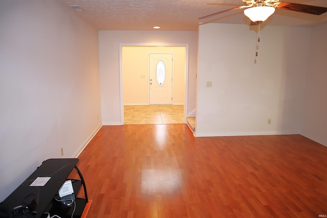 entrance foyer with a textured ceiling, light hardwood / wood-style flooring, and ceiling fan