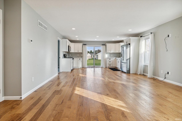 unfurnished living room with light wood-type flooring