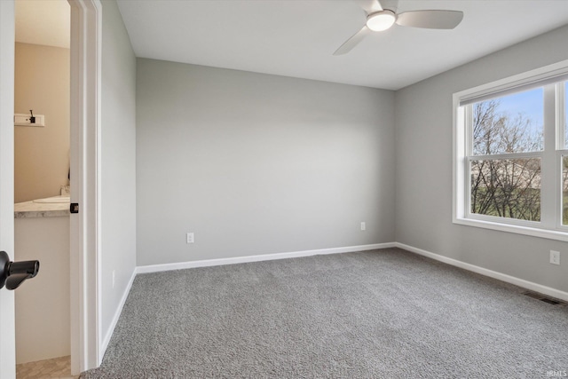 carpeted empty room with ceiling fan