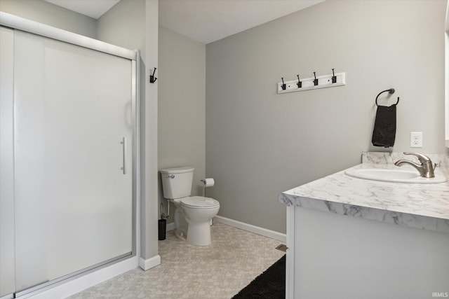 bathroom with vanity, toilet, and a shower with shower door