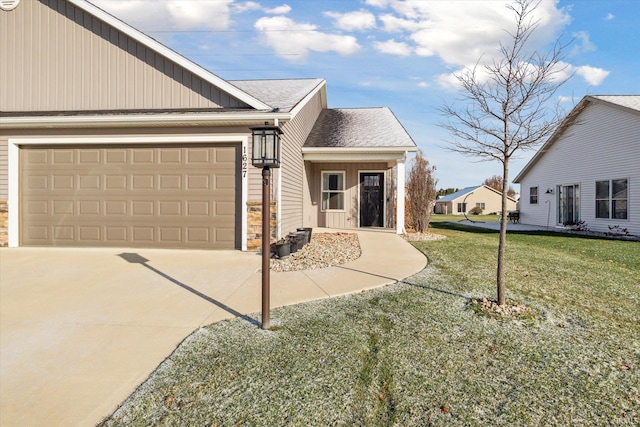 view of front of home with a garage and a front yard