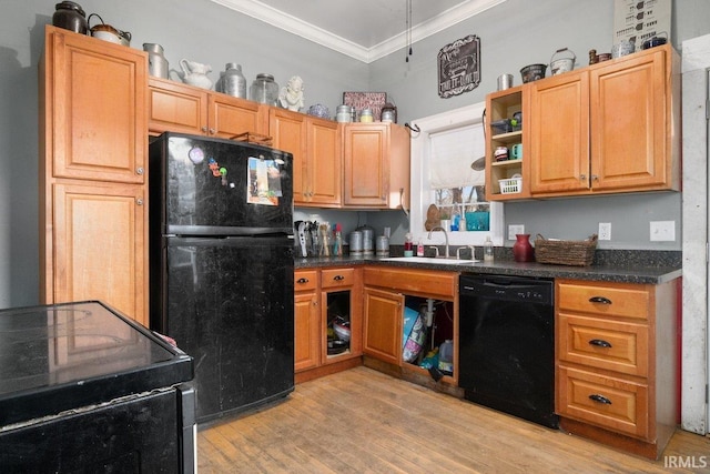 kitchen with crown molding, sink, black appliances, and light hardwood / wood-style floors