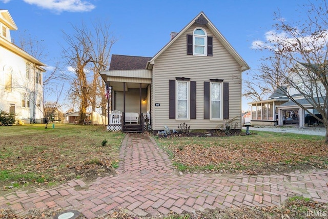 view of property featuring a front yard and a porch