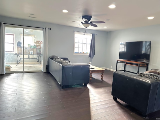 living room with ceiling fan and dark wood-type flooring