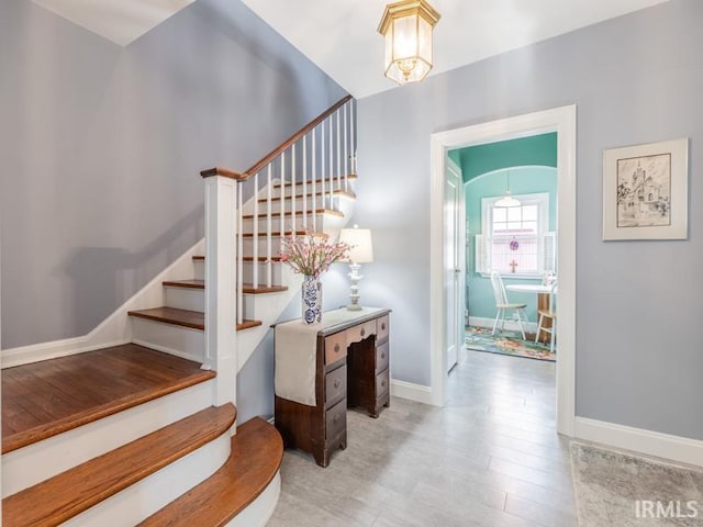 stairway with hardwood / wood-style floors