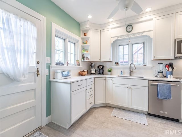 kitchen with white cabinets, a healthy amount of sunlight, sink, and appliances with stainless steel finishes