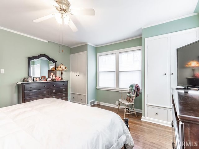 bedroom featuring ceiling fan, ornamental molding, and light hardwood / wood-style flooring