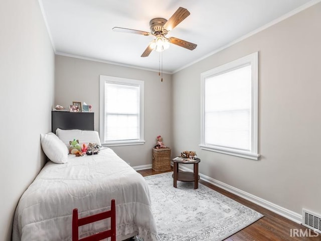 bedroom with hardwood / wood-style flooring, ceiling fan, and ornamental molding