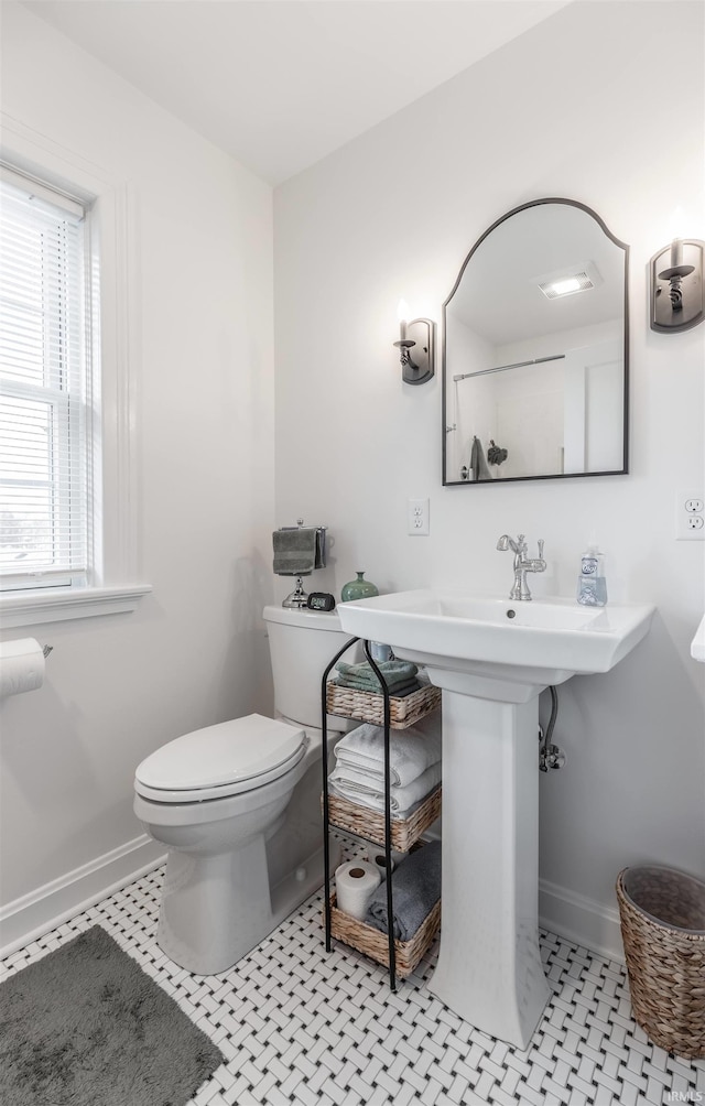 bathroom with tile patterned flooring, toilet, and sink