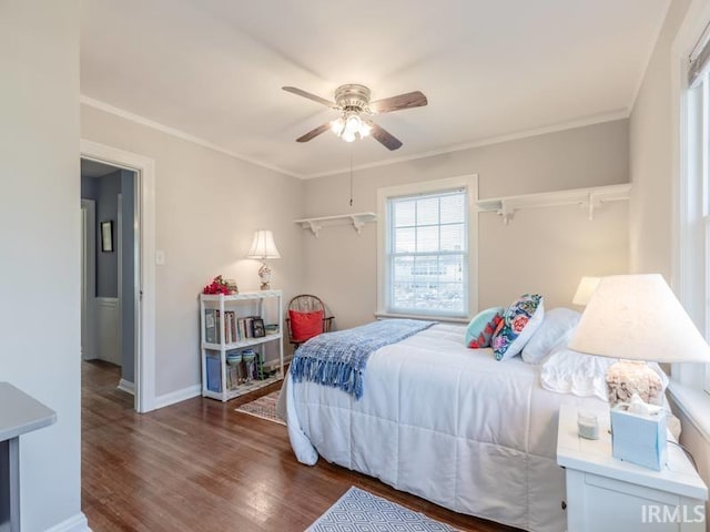 bedroom featuring ceiling fan, crown molding, and dark wood-type flooring