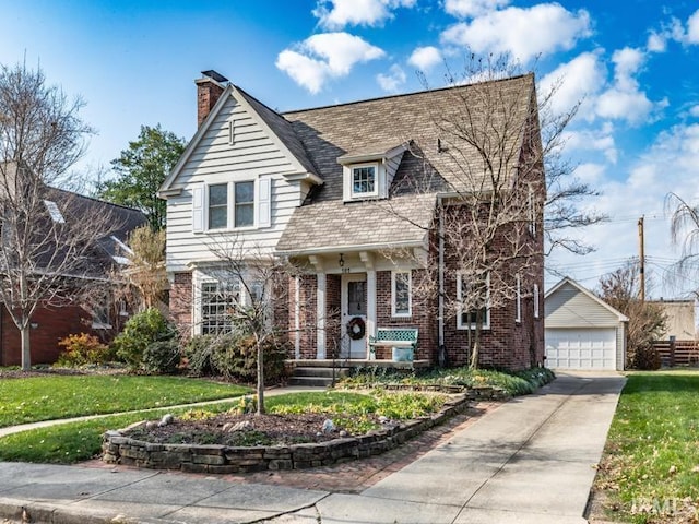 view of front of property with a front yard, an outdoor structure, and a garage