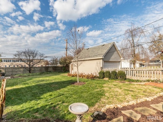 view of yard featuring an outbuilding and a garage