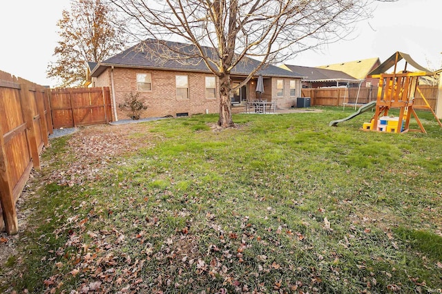 view of yard with a playground and central AC