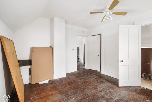 unfurnished bedroom featuring dark hardwood / wood-style floors, ceiling fan, and lofted ceiling