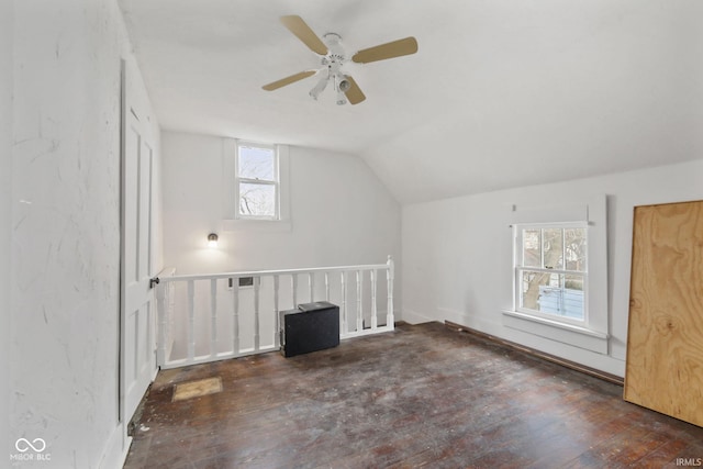 additional living space with dark hardwood / wood-style floors, ceiling fan, and vaulted ceiling