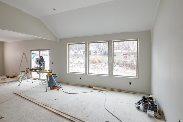 empty room featuring lofted ceiling