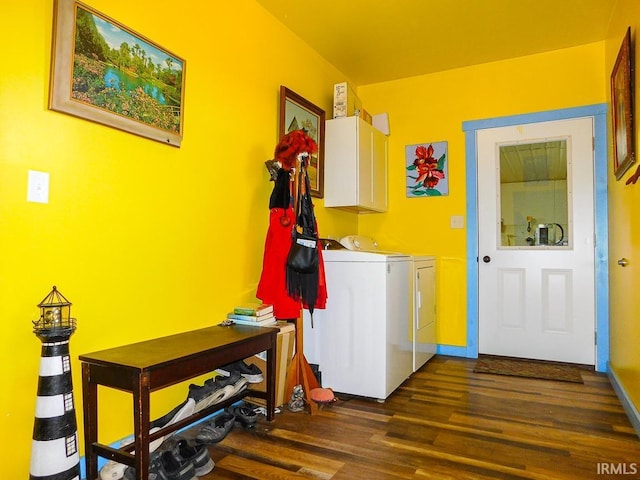 laundry room featuring separate washer and dryer, dark hardwood / wood-style flooring, and cabinets