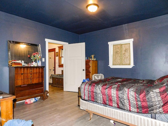 bedroom with hardwood / wood-style floors