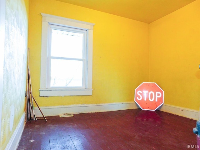 empty room with dark wood-type flooring