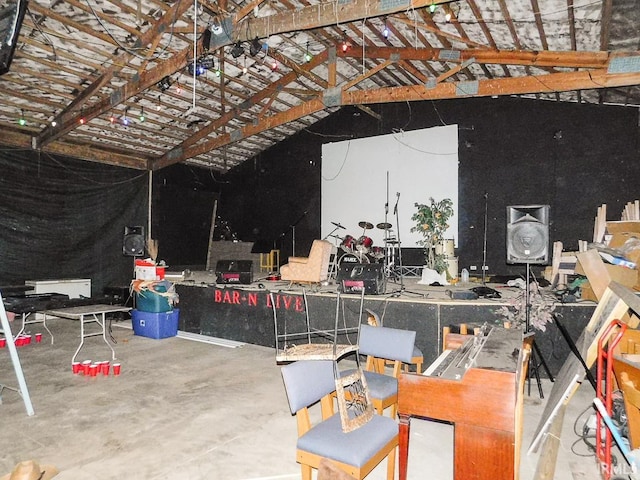 interior space with concrete flooring and vaulted ceiling