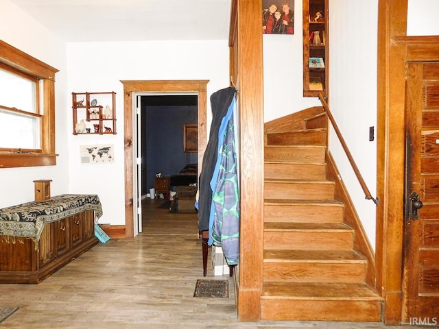 staircase with hardwood / wood-style flooring