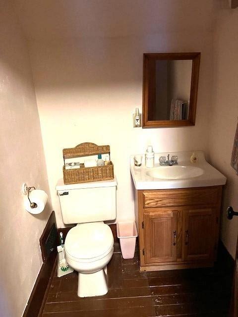 bathroom with vanity, hardwood / wood-style flooring, and toilet