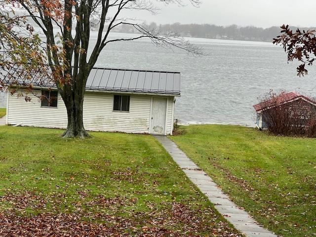 exterior space featuring a yard and a water view