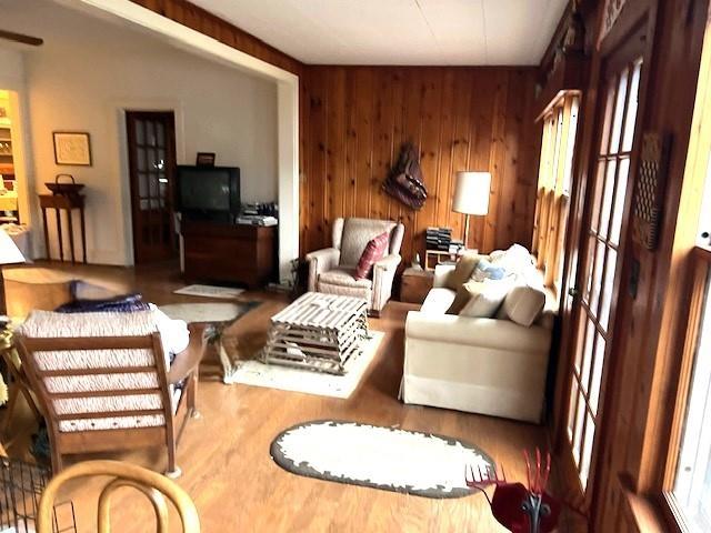 living room featuring wood walls and wood-type flooring