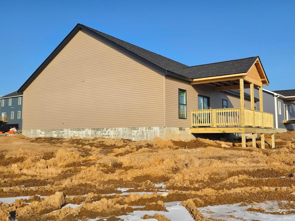 snow covered property featuring a wooden deck