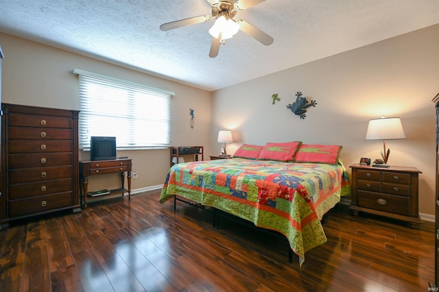 bedroom with a textured ceiling, ceiling fan, and dark hardwood / wood-style floors