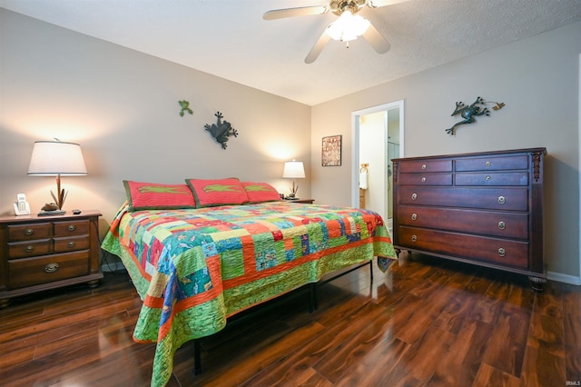 bedroom with a textured ceiling, dark hardwood / wood-style flooring, ensuite bathroom, and ceiling fan