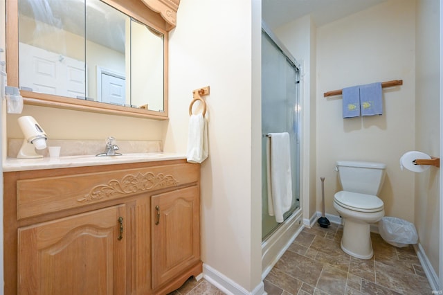 bathroom featuring vanity, toilet, and walk in shower