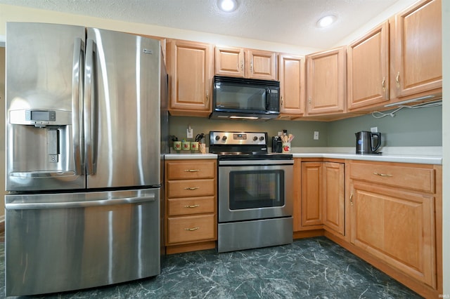 kitchen with appliances with stainless steel finishes and a textured ceiling