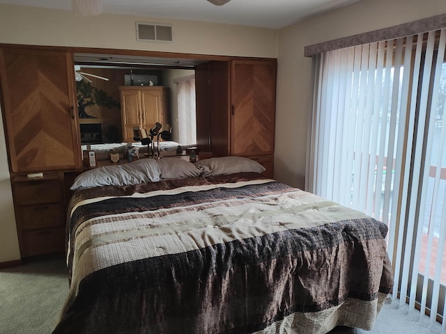 bedroom with light carpet and ceiling fan