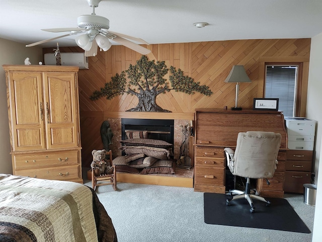 bedroom featuring carpet, an AC wall unit, ceiling fan, and wooden walls