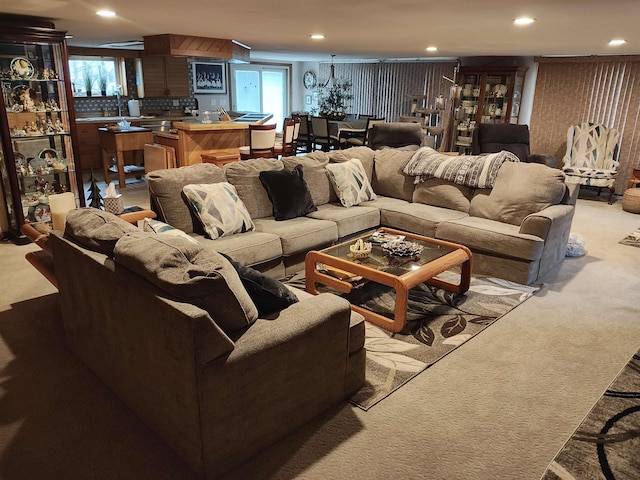 carpeted living room featuring wood walls