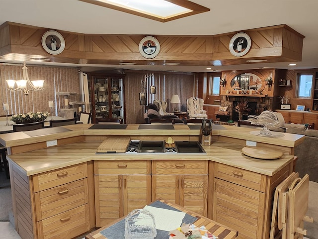 kitchen featuring a chandelier and wood walls