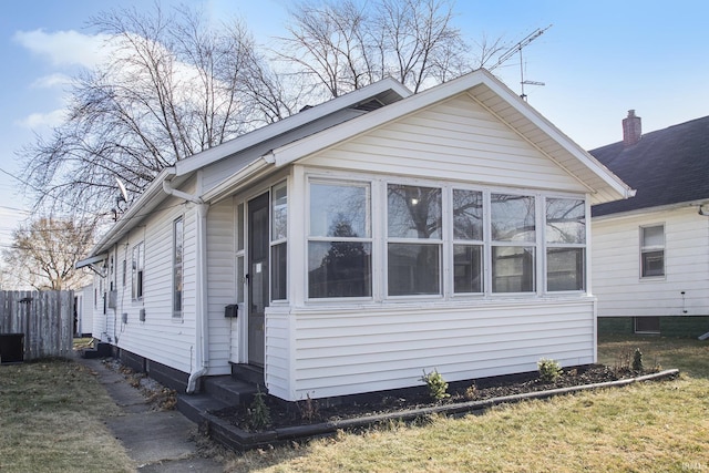 view of front of home with cooling unit and a sunroom