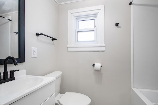 bathroom featuring crown molding, vanity, and toilet