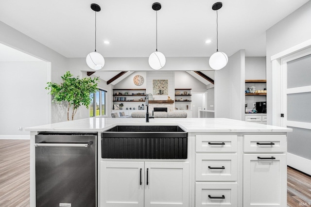 kitchen featuring pendant lighting, light wood-type flooring, white cabinetry, and sink