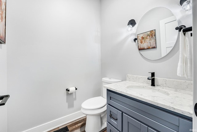 bathroom featuring hardwood / wood-style floors, vanity, and toilet