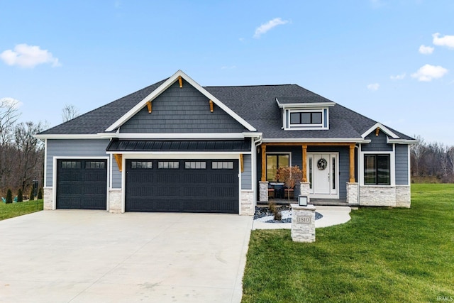 craftsman-style home with a front yard and a garage